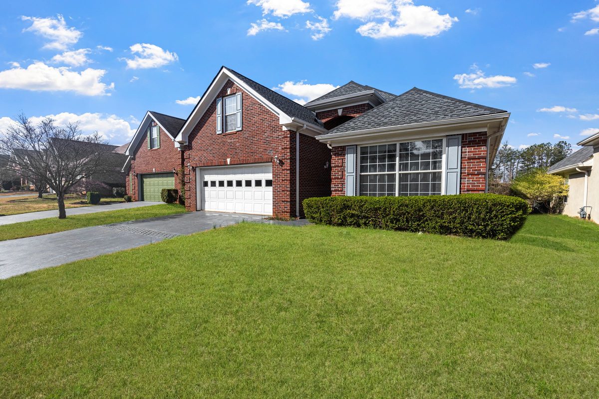 Brick one-story home with a two-car garage and a wide front lawn